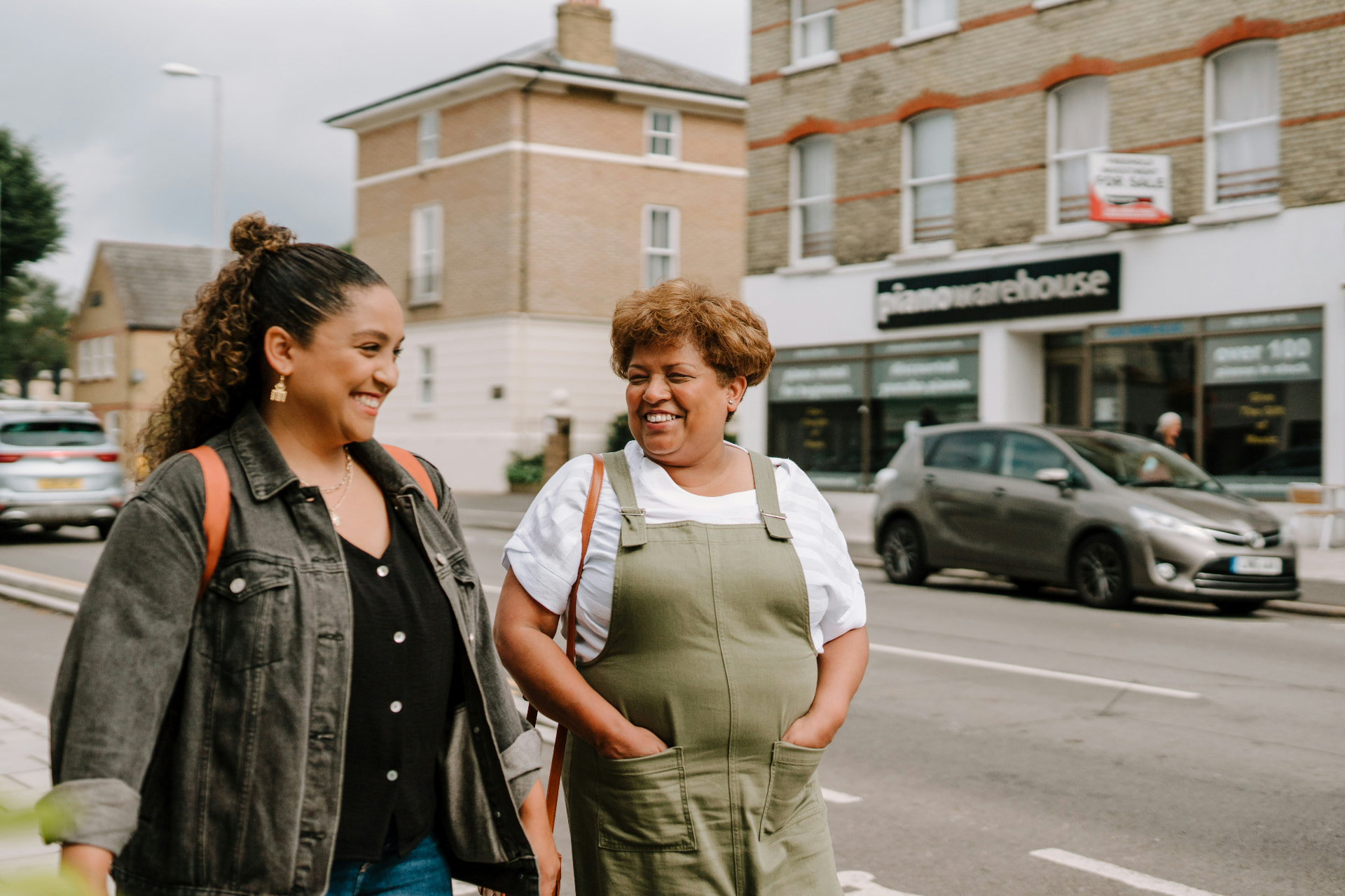 Two women walking and talking on a British high street